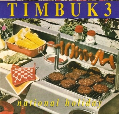 National Holiday - Timbuk 3 (Singiel, Winyl, 12", ℗ © 15 Sty 1990 Wielka Brytania, I.R.S. Records #EIRST 132) - przód główny